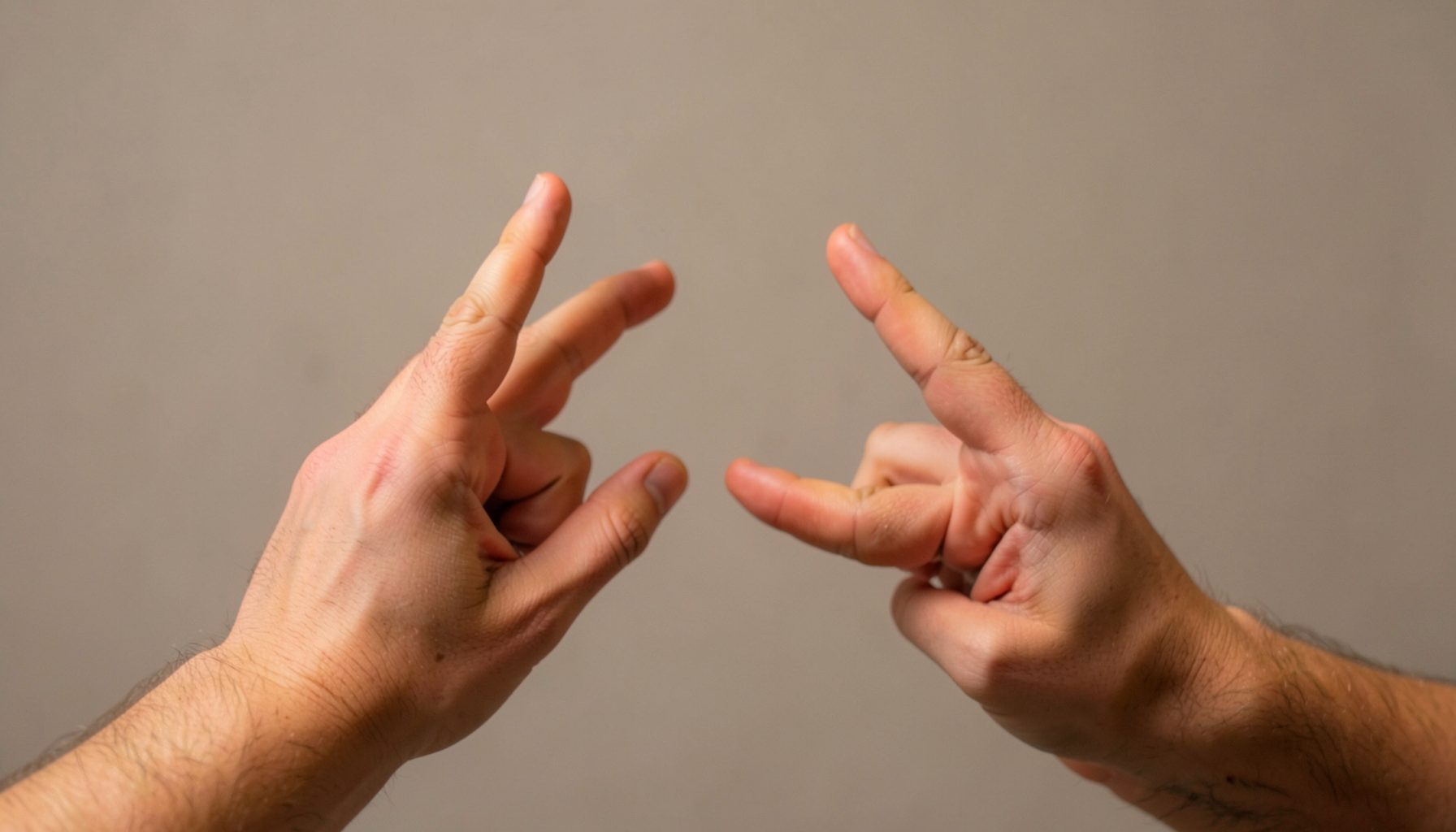 Hands gesturing expressively against a warm neutral background, representing sign language education